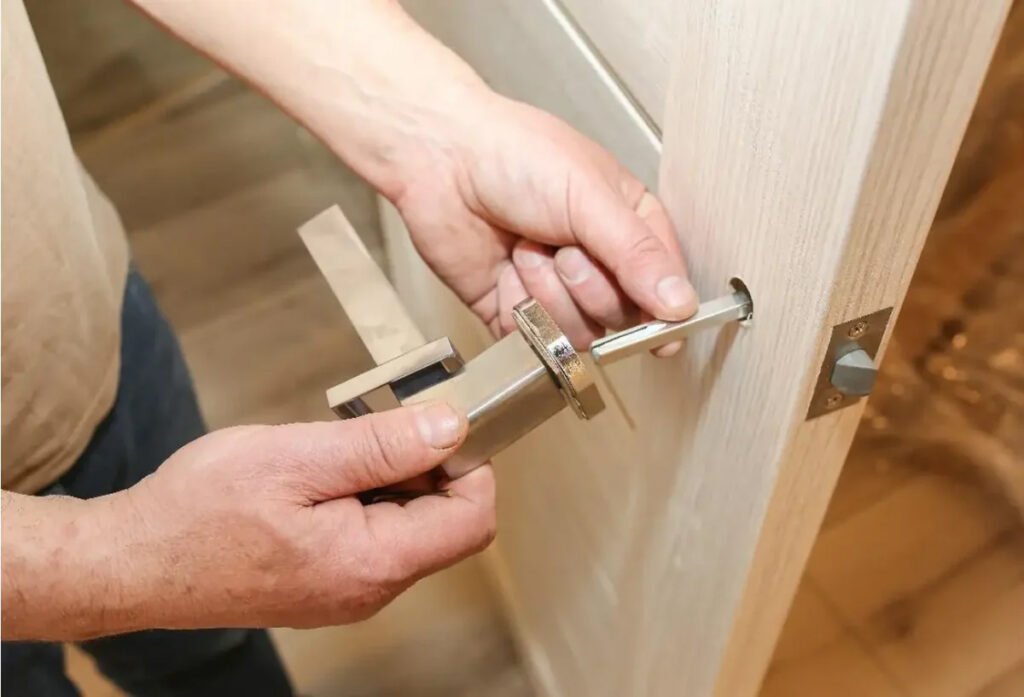 Door hardware replacement Pleasantville NY close up shot a man replacing a door knob