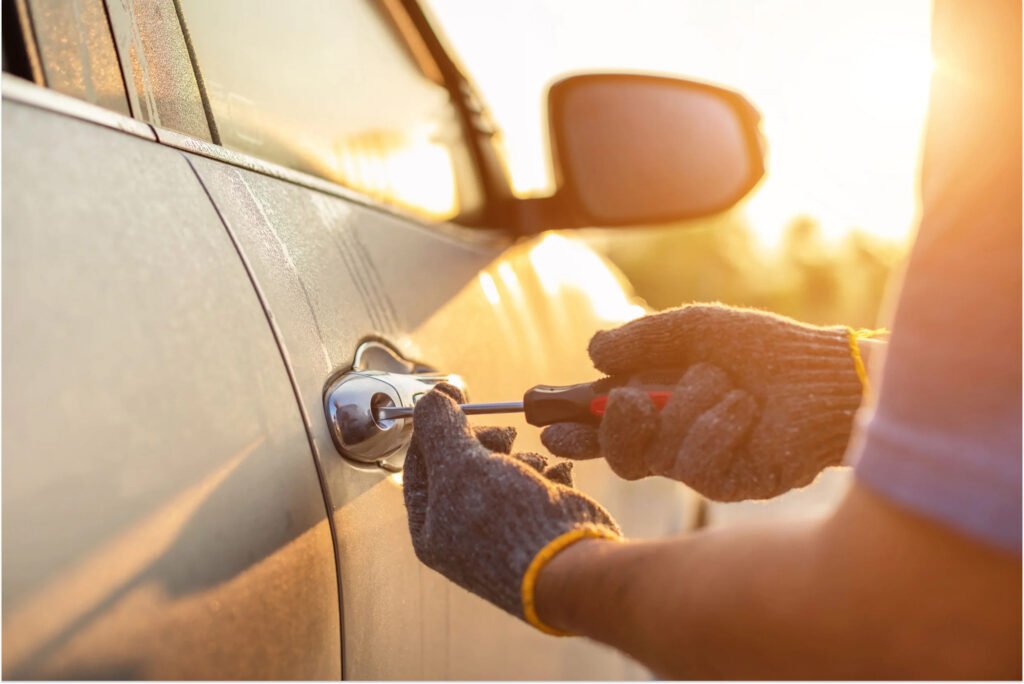 Lock repair for sticking or loose locks close up hand wearing gloves and tool fixing the doornob of a car
