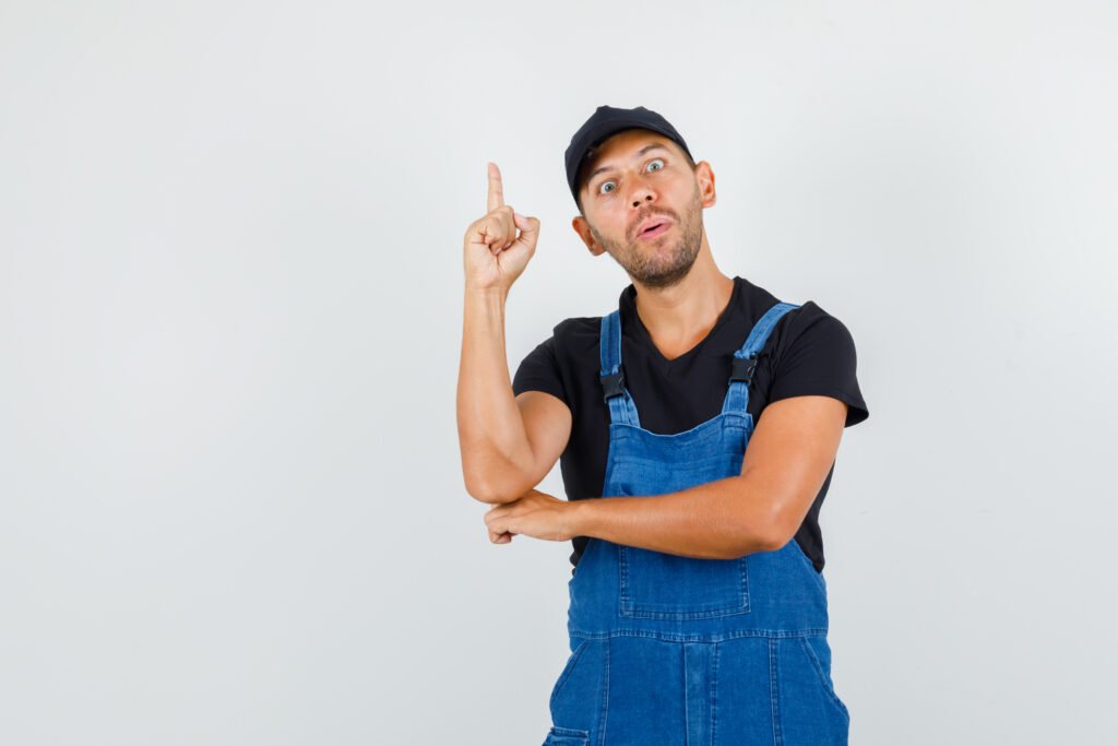 Lock replacement NY for damaged or outdated hardware young mechanic pointing up uniform looking curious