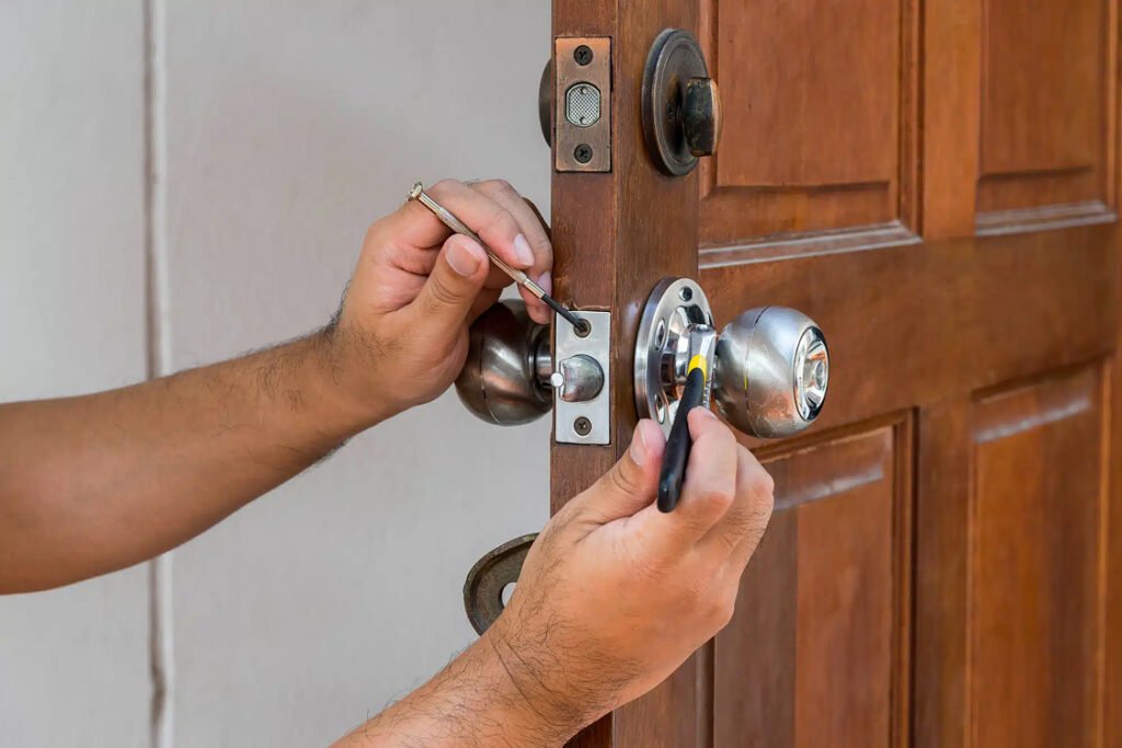 deadbolt installation Pleasantville, NY close up two hands fixing a door knob