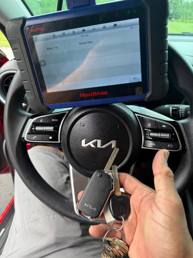 hand holding a kia key while programming