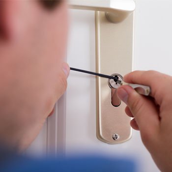 hand of a locksmith unlocking the door lock